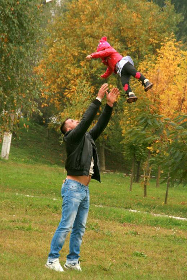 Dad Playfully Tossing His Child Wallpaper