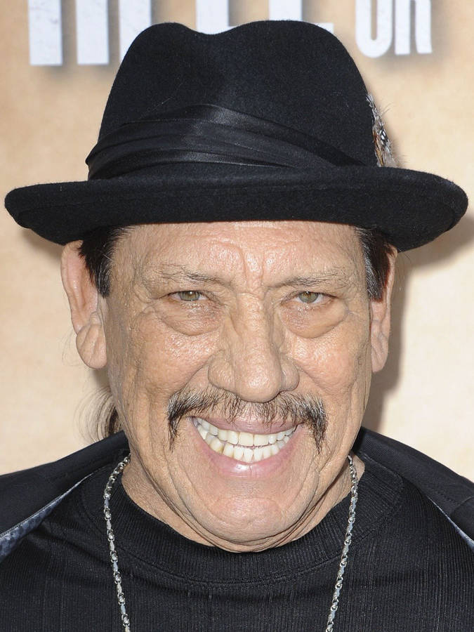 Danny Trejo Smiling In A Headshot Wallpaper