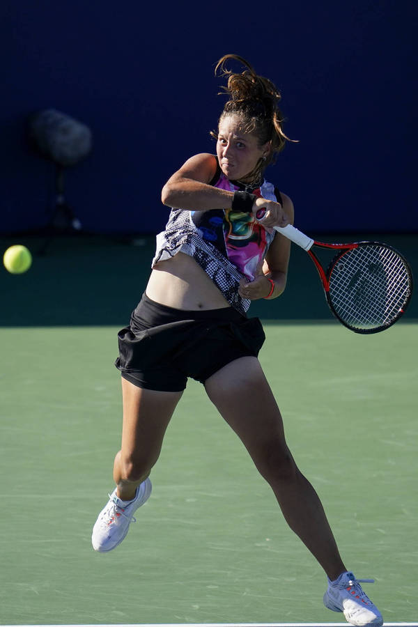 Daria Kasatkina Delivers A Powerful Swing During A Tennis Match Wallpaper