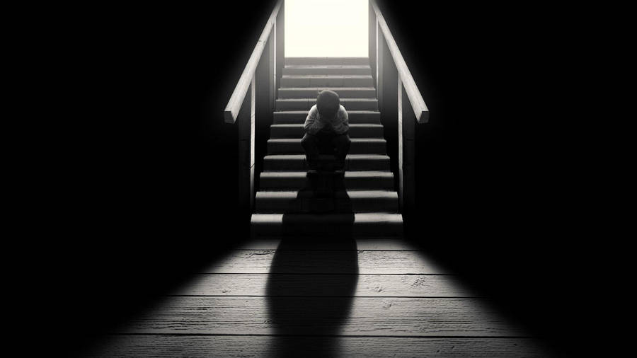 Dark Loneliness: A Solitary Figure On A Staircase Wallpaper