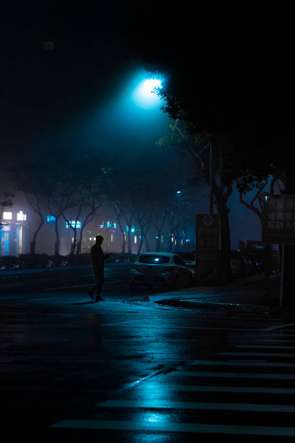 Dark Night Man Crossing Street Wallpaper