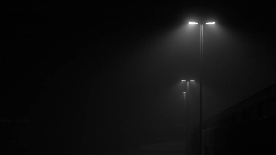 Dark Theme Series Of Lamp Posts At Night Wallpaper