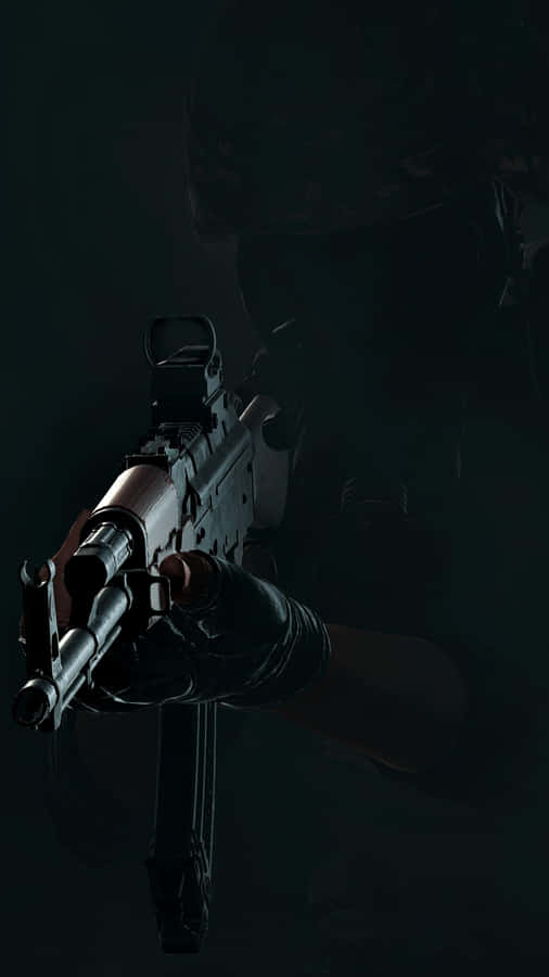 Darkened_ Figure_ Holding_ Gun Wallpaper