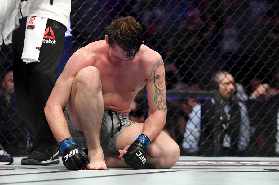 Darren Till Resting On Octagon Wallpaper