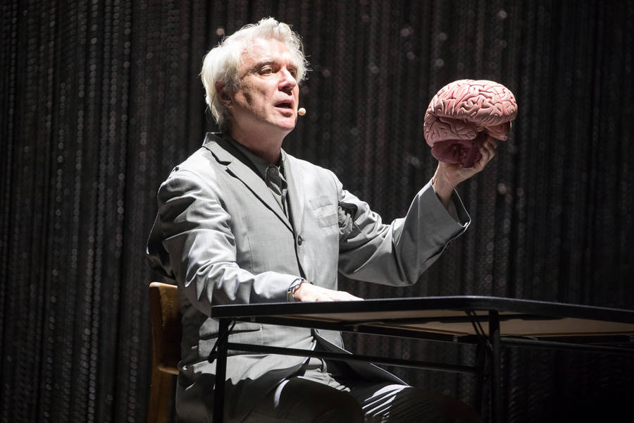 David Byrne American Utopia Holding Brain Photo Wallpaper