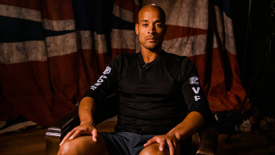 David Goggins Posing In Chair Wallpaper