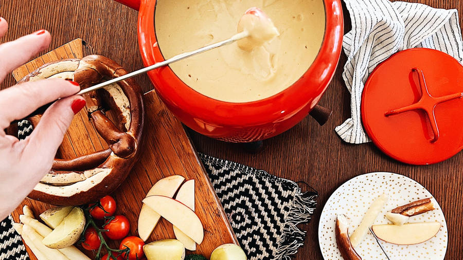 Delectable Cheese Fondue Served With Fresh Apples Wallpaper