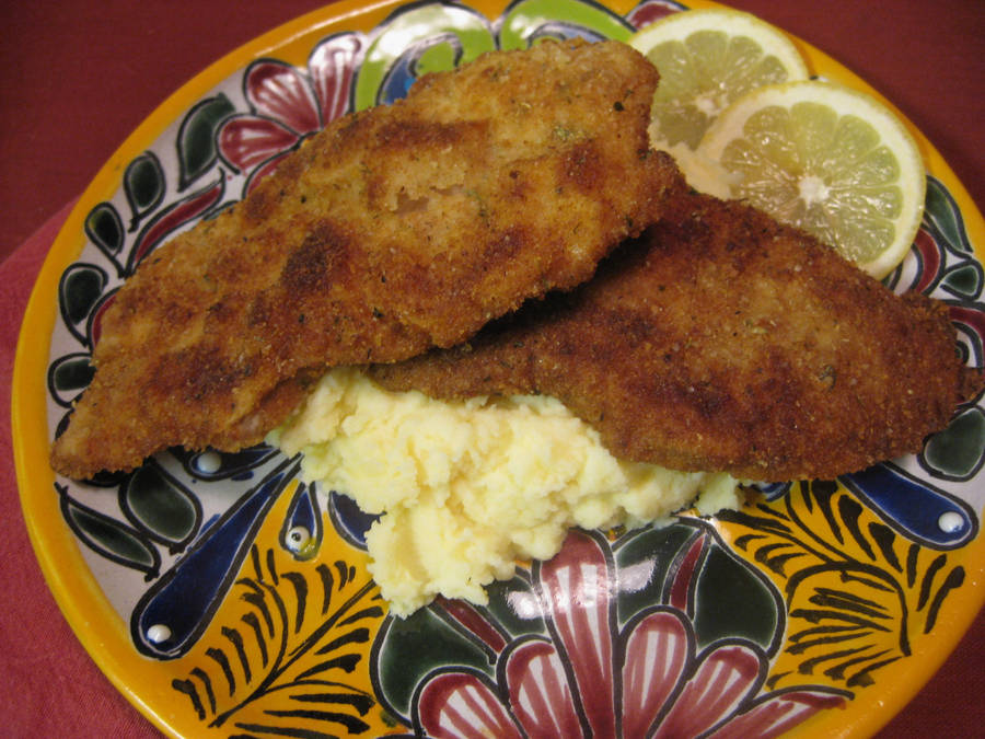 Delectable Wiener Schnitzel Served With Creamy Mashed Potatoes. Wallpaper