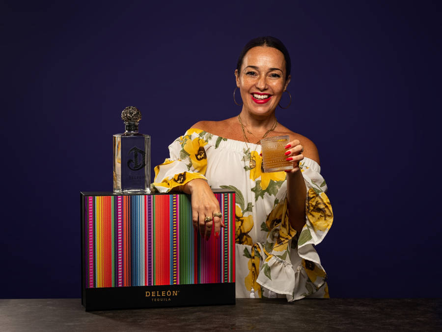 Deleón Tequila With A Smiling Lady Wallpaper