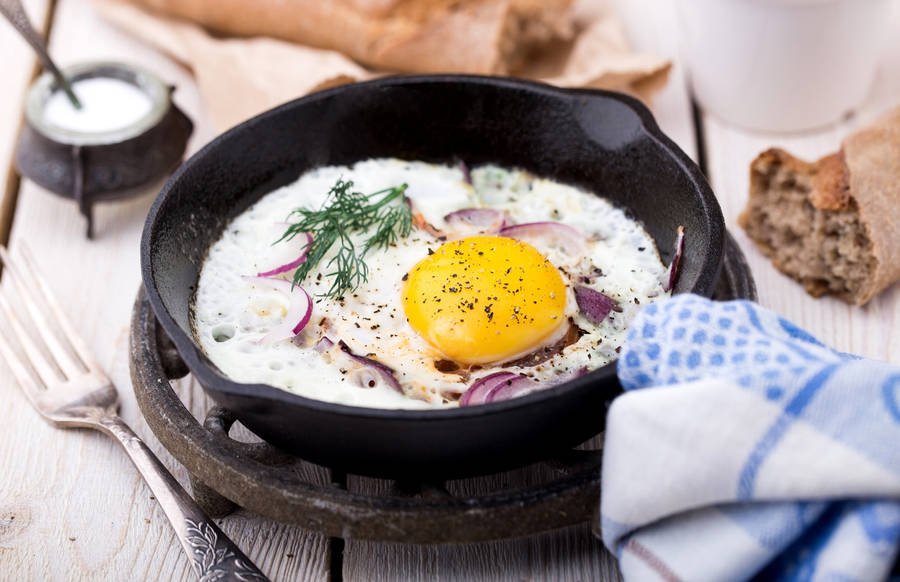 Delicious Fried Egg Seasoned With Herbs Wallpaper