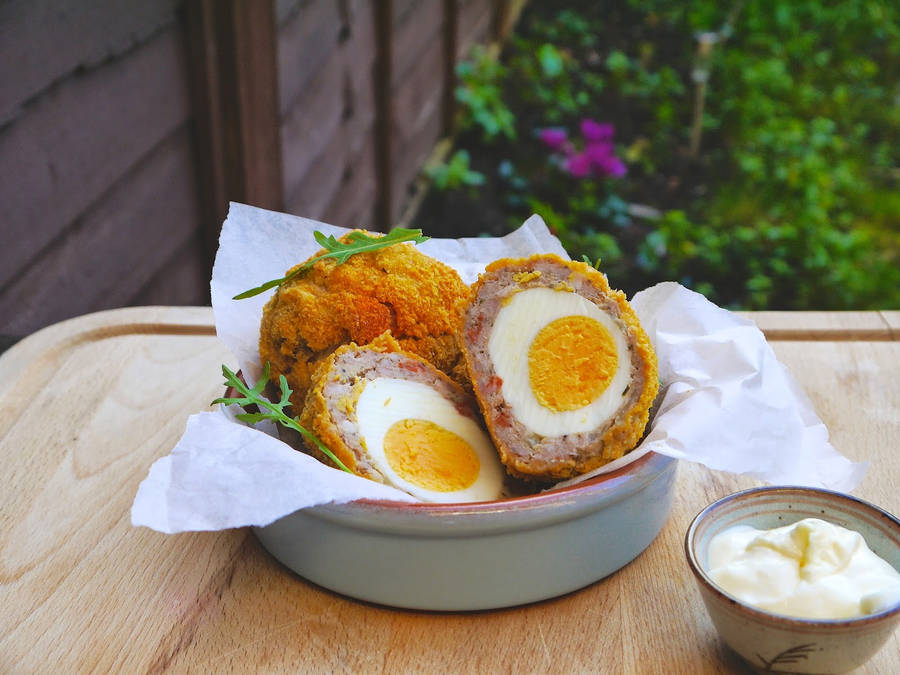 Delicious Traditional British Scotch Eggs On A White Napkin Wallpaper