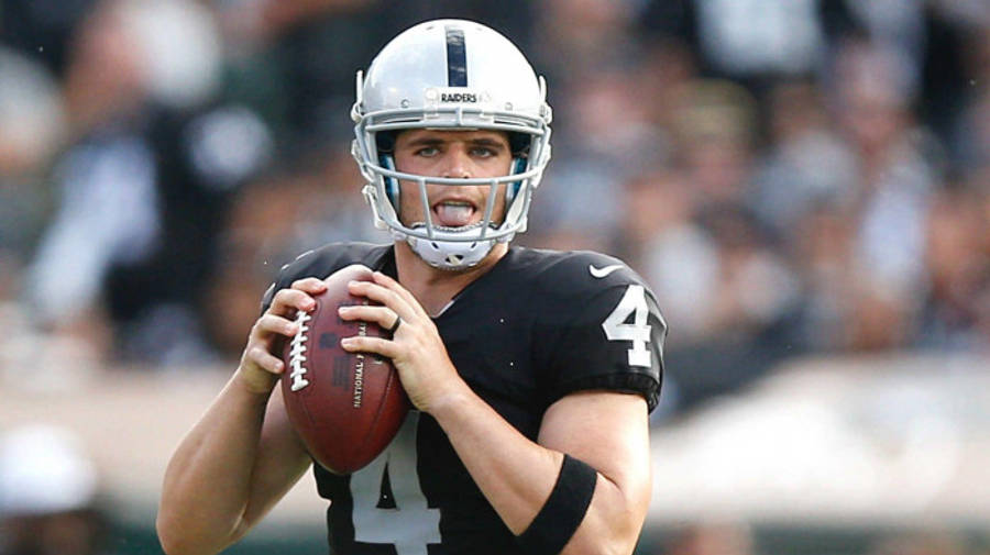 Derek Carr Holding Football With Two Hands Wallpaper