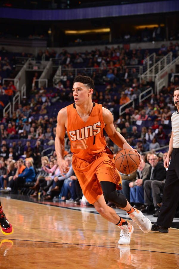 Devin Booker Dribbling Ball On Court Wallpaper