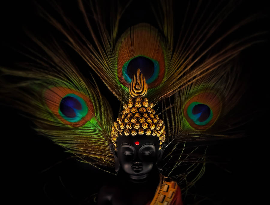 Devotion In Colors: Divine Image Of Vithu Mauli Adorned With Peacock Feathers Wallpaper