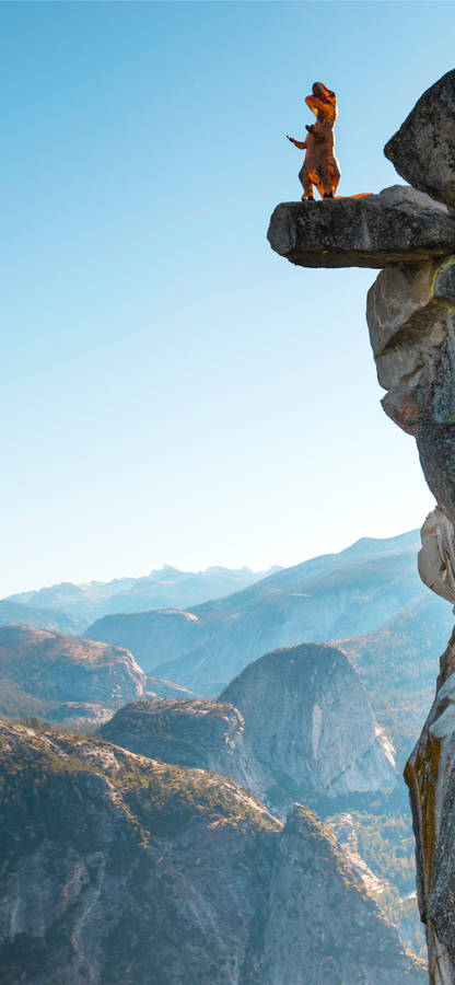 Dinosaur Climbing A Rock Wallpaper