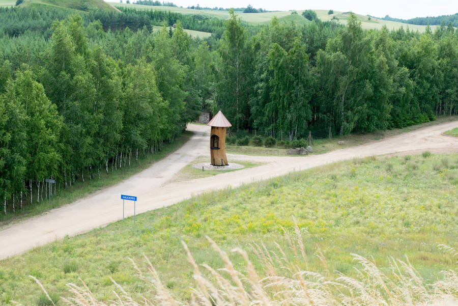 Dirt Road With Wooden Tower In Lithuania Wallpaper