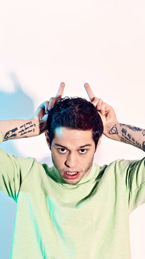 Distinctive Portrait Of Pete Davidson During A Complex Interview Wallpaper