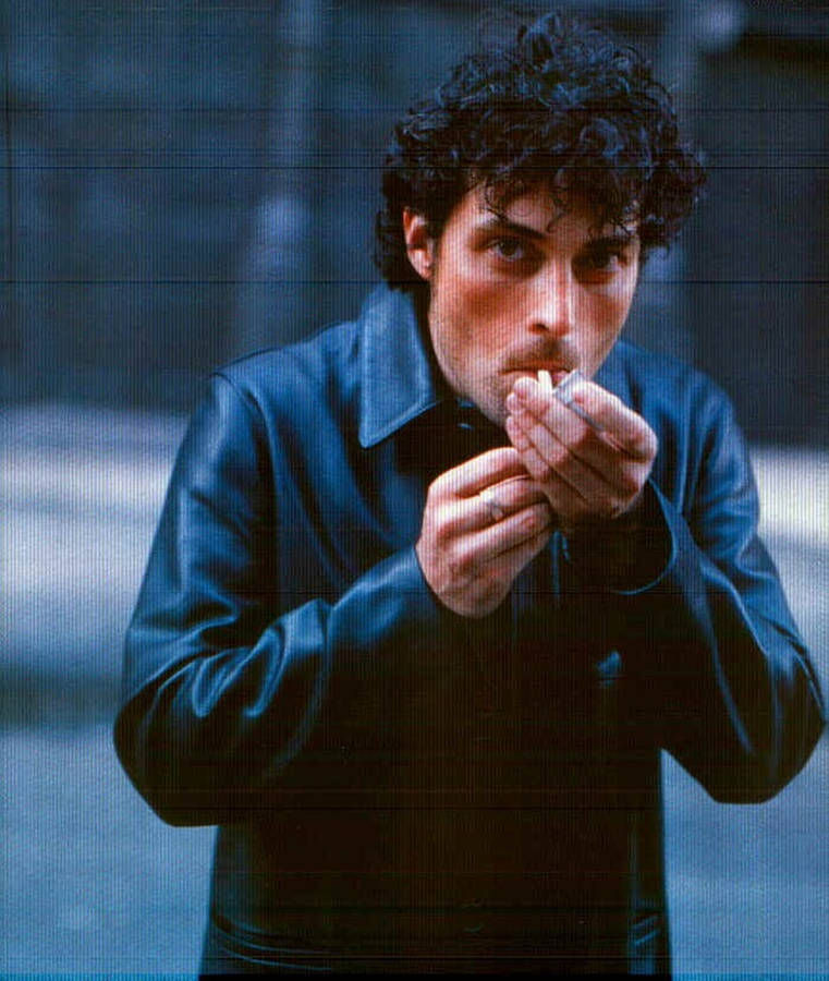 Distinguished Actor Rufus Sewell Enjoying A Smoke Break Wallpaper