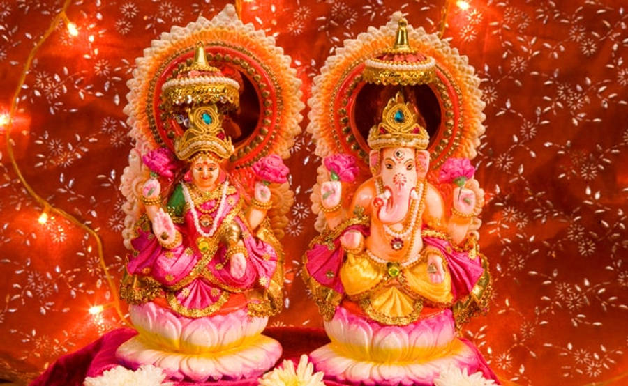 Divine Figurines Of Ganesh And Lakshmi Wallpaper