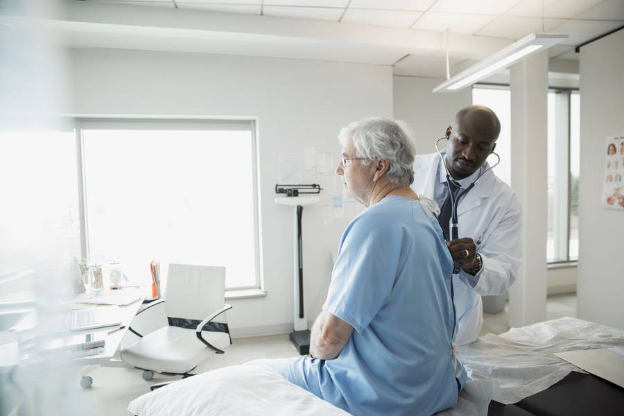 Doctor Checking Patient's Heartbeat Wallpaper