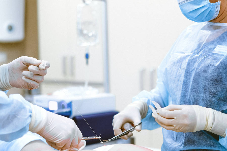 Doctors Performing A Suture Wallpaper