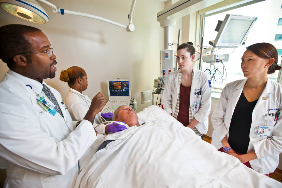 Doctors Surrounding Patient Wallpaper