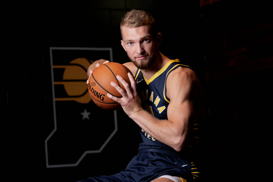 Domantas Sabonis Holding A Ball Wallpaper