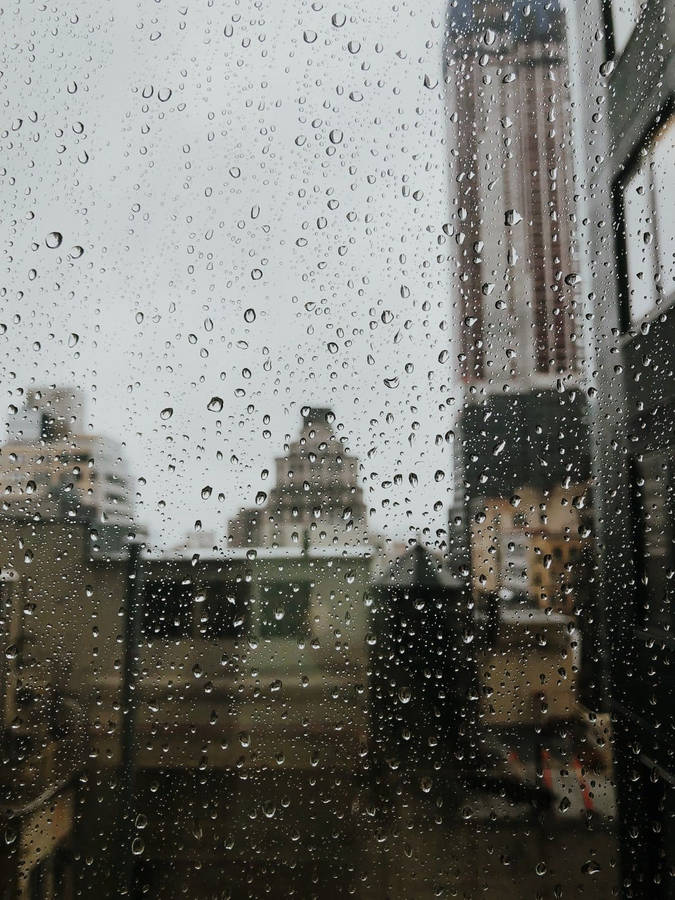 Dramatic Raindrops On Window Glass Pane Wallpaper