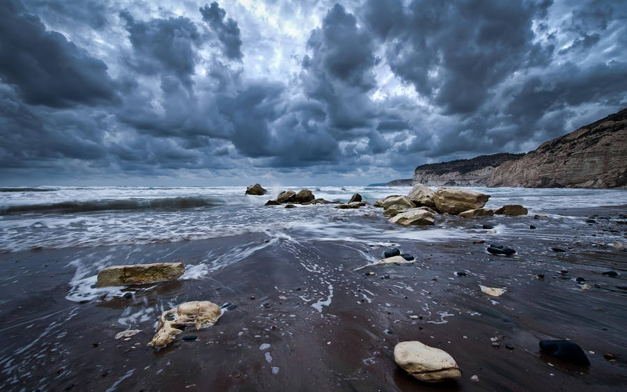 Dramatic Storm Rolling In Over Rocky Beach Retina Image Wallpaper