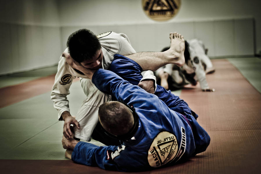 Dynamic Brazilian Jiu-jitsu Rolling Technique Wallpaper