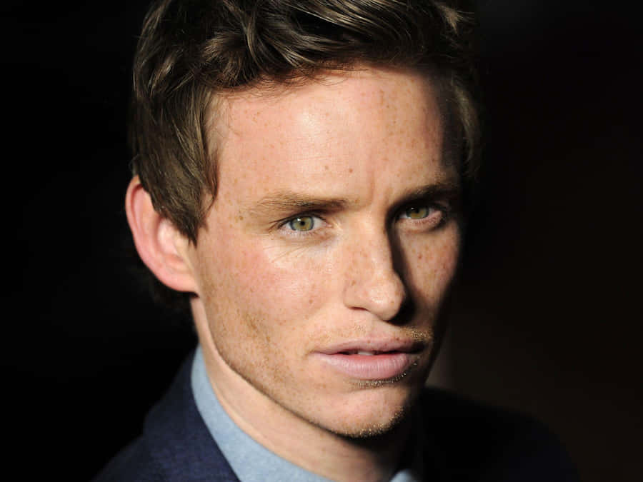 Eddie Redmayne Striking A Pose At An Event Wallpaper