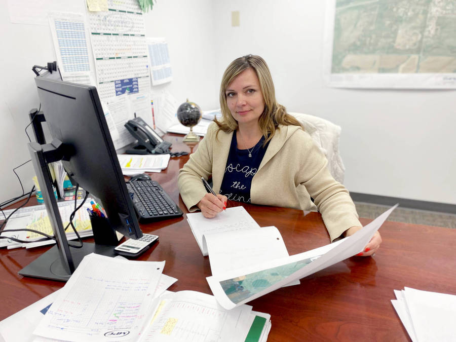 Efficient Secretary At Work In A Residential Building Office Wallpaper