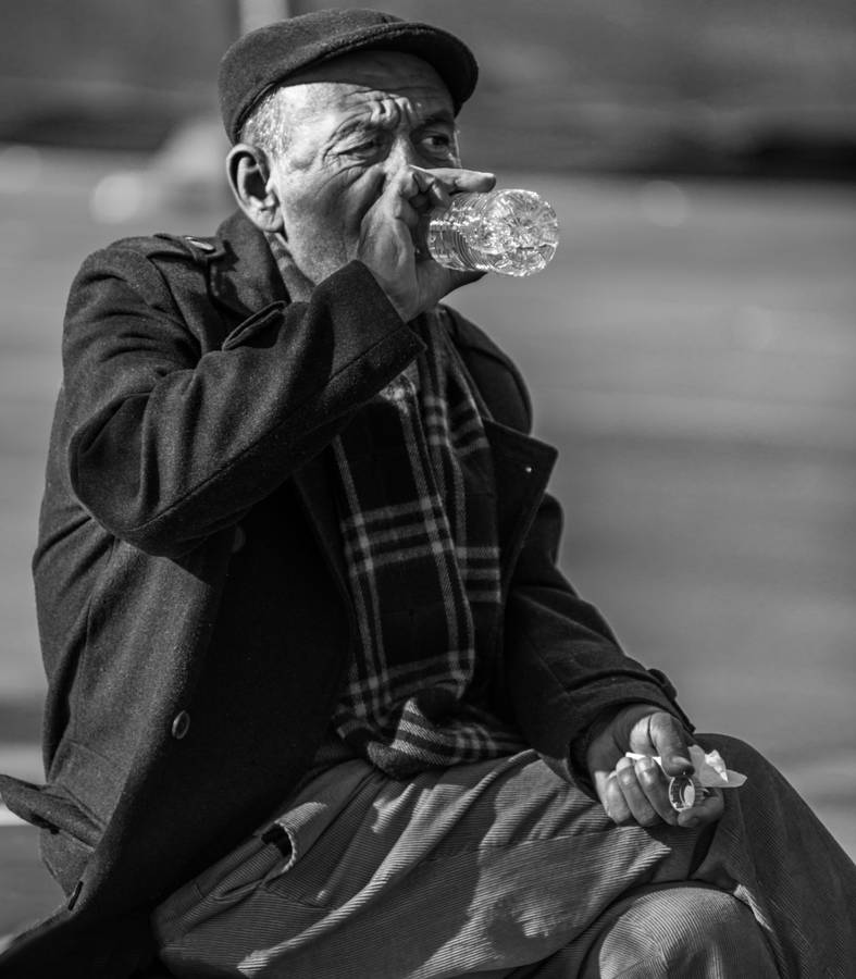 Elderly Man Enjoying Fresh Drinking Water Wallpaper