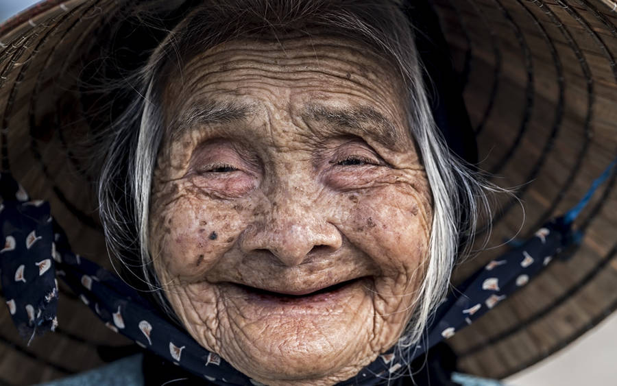 Elderly Woman Beaming Smile Wallpaper