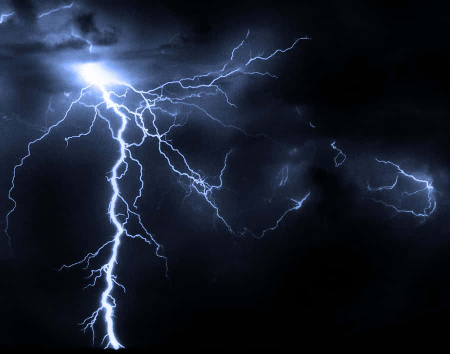 Electric Blues - A Mesmerizing Image Of Blue Lightning In A Dark Night Sky Wallpaper