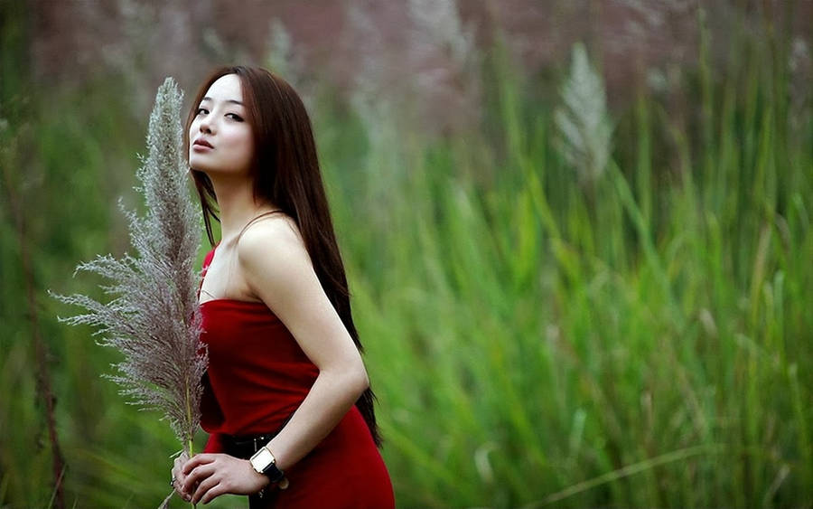 Elegant Chinese Girl In Traditional Red Dress Wallpaper