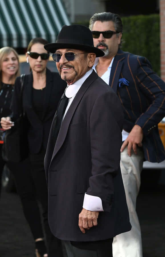 Elegant Man Black Hat Suit Outdoors Wallpaper