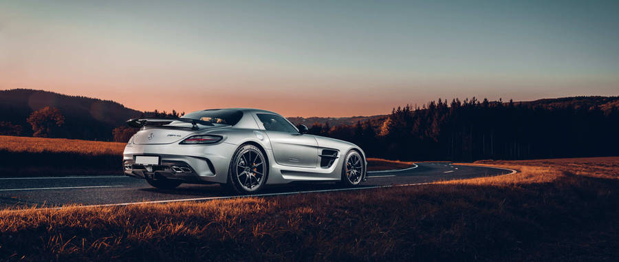 Elegant Mercedes Benz Amg Gliding Down The Highway Wallpaper