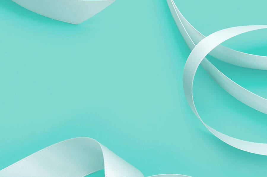 Elegant White Ribbon On Tiffany Blue Backdrop Wallpaper