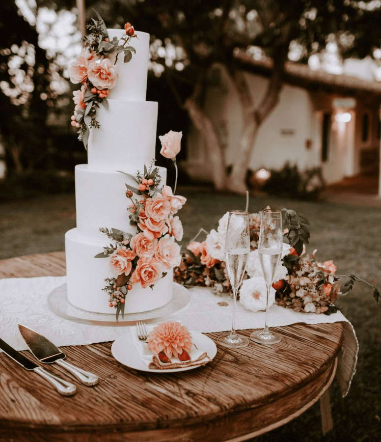 Elegant White Wedding Cake Adorned With Delicate Pink Roses Wallpaper