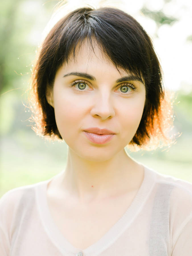 Elegant Woman In White Top Headshot Wallpaper