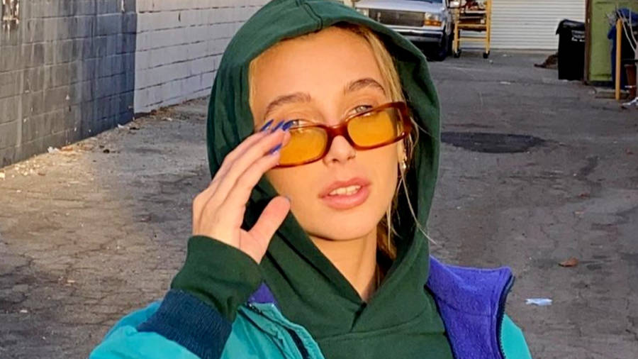 Emma Chamberlain In Green Hoodie Wallpaper