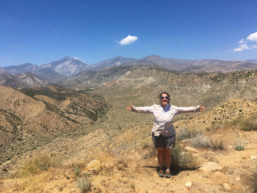 Empowered Woman On A Scenic Hike Wallpaper