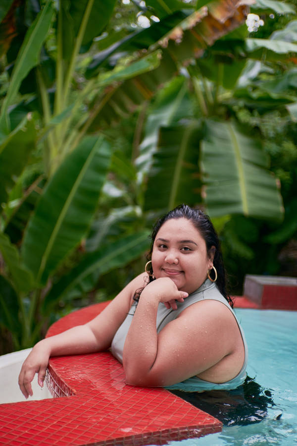 Empowering Confidence - Plus Size Woman Enjoying A Pool Day Wallpaper