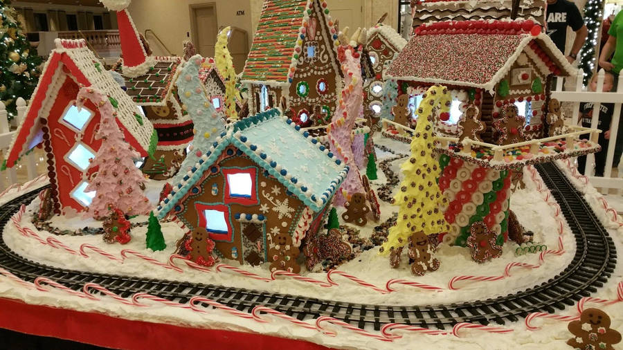 Enchanting Gingerbread House Village With Toy Train Wallpaper