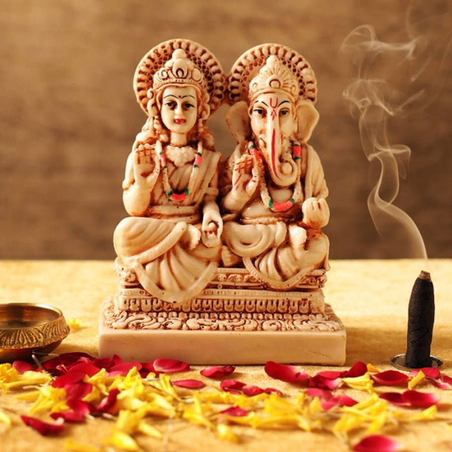 Enchanting Sculpture Of Ganesh Lakshmi Wallpaper