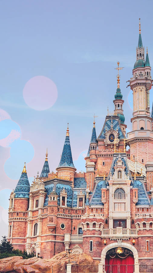 Enchanting View Of Shanghai Disneyland Castle In Pink Wallpaper