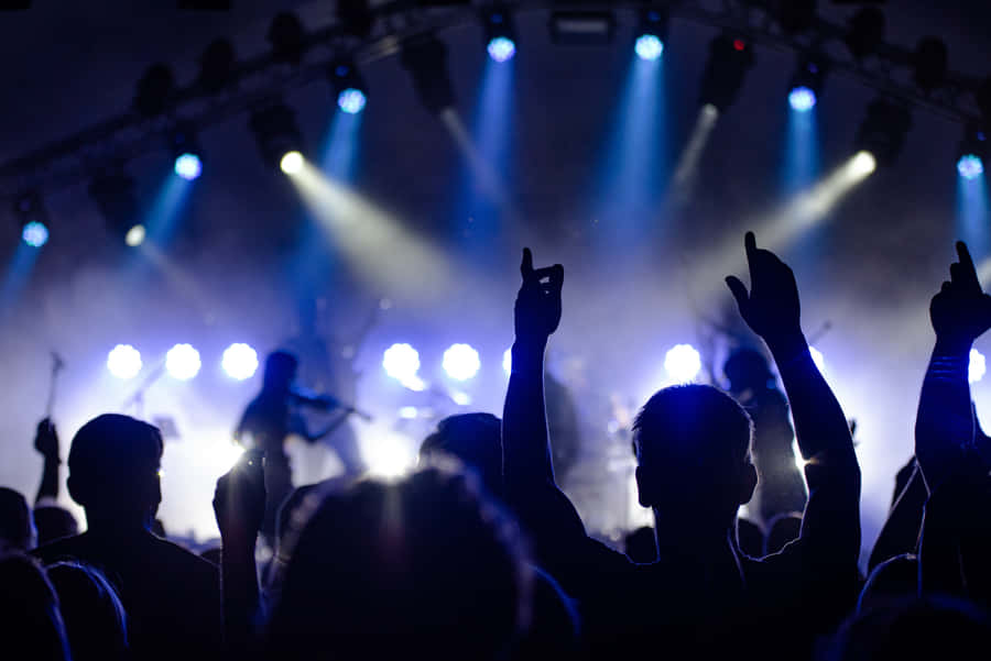 Energetic Crowd Enjoying An Unforgettable Music Festival Wallpaper