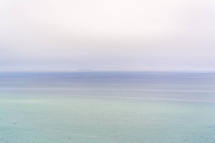 Enjoying The Natural Beauty Of An Ombre Ocean Landscape Wallpaper