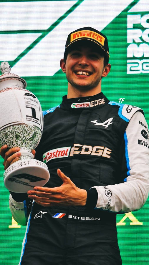 Esteban Ocon Holding Race Trophy Wallpaper